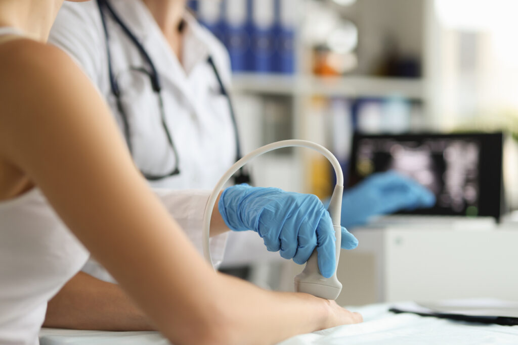 Sonographer scans a ganglion cyst on a woman's wrist.