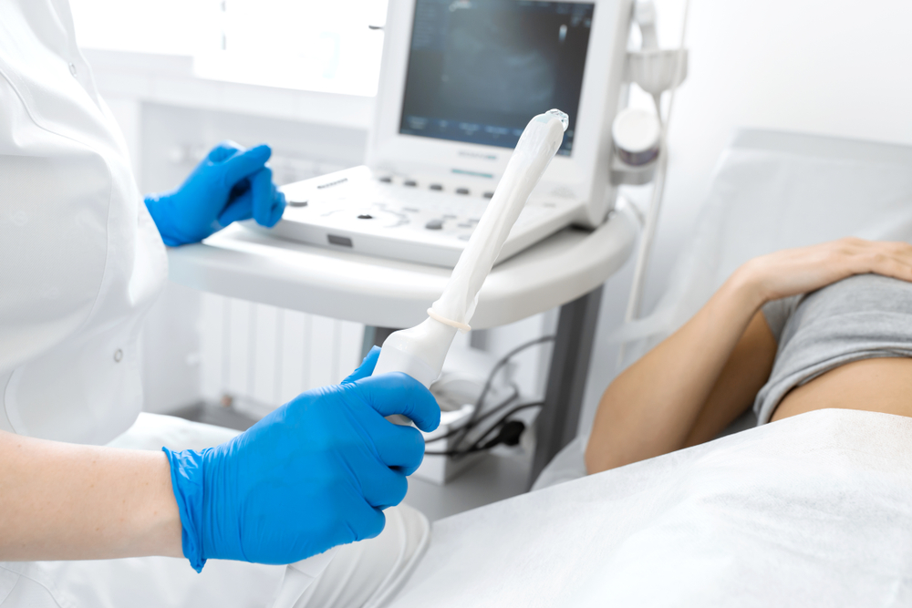 Sonographer prepares to do ultrasound of patient with pelvic pain.